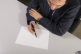 Businessman writing on a blank paper