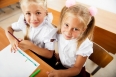 Little girls drawing pictures and writing letters to Santa Claus