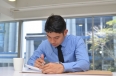 Businessman filling in a note