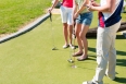 People playing miniature golf outdoors