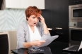 Elderly woman sorting through her old receipts