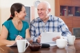 Happy senior couple holding  documents