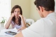 Upset young woman and man sitting with home bills at the table