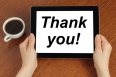 Hands hold tablet PC with "thank you" text